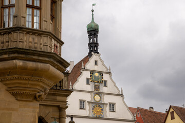 Obraz premium Market Square of Rothenburg ob der Tauber with historic Town Hall Tower, Ratstrinkstube Clock Tower, half‑timbered houses, cobblestone streets, fountain and shops in medieval Bavarian town