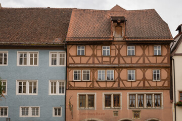 Fototapeta premium Colorful half-timbered houses in Rothenburg ob der Tauber, Bavaria, Germany. Medieval timber framed facades and quaint historic streets in a scenic European old town.