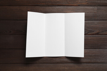 Blank brochure on wooden background