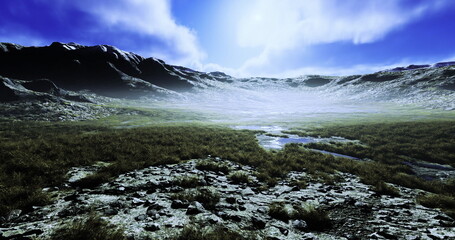 Obraz premium A serene mountain landscape features rocky terrain with patches of grass, mist hovering above, and sunlight filtering through clouds. The scene conveys tranquility and natural beauty.