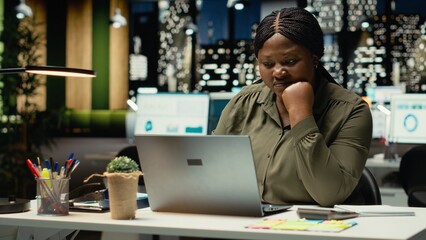 Female entrepreneur sighing being drained and overwhelmed after hours, pushing limits despite clear signs of fatigue and tension. Workplace challenges and discouragement bring discomfort. Camera B.