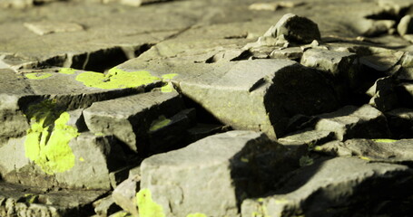 Old stone landscape, Calm meadow featuring ancient mosscovered stone, Serene grassy terrain with worn lichencovered boulders and gentle slopes