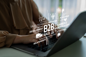 A businesswoman engages with her laptop, showcasing dynamic e-commerce graphics highlighting B2B...