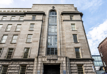 Obraz premium The facade of the Department of Industry and Commerce adorned with bas‑relief sculptures by Irish female artist Gabriel Hayes, on Kildare Street, Dublin, Ireland.