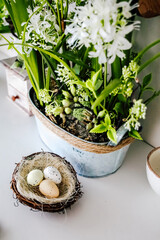 Natural decor with flowers and eggs displayed on a table in a spring setting during daytime