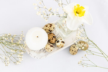 Decorative tray with eggs candle and flowers on white surface for spring celebration Easter