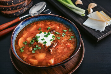 Bowl of red beetroot soup borscht with white cream