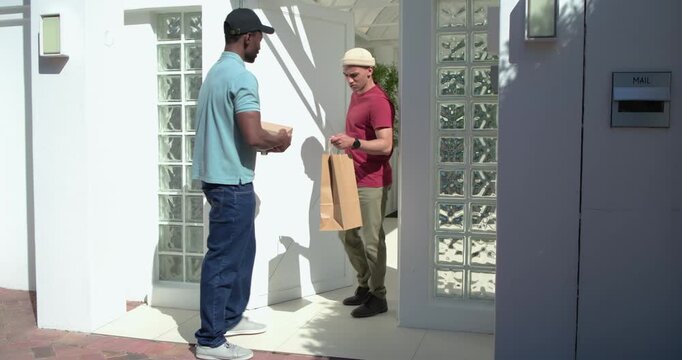 Male courier knocking on front door handing pizza boxes scanning QR code confirming delivery