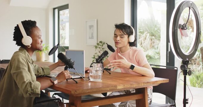 African American woman speaking into mic signaling ringlight fix while male cohost pausing at home