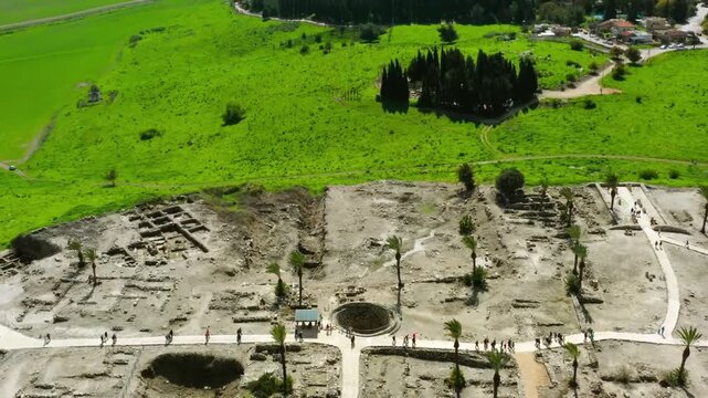 Aerial view of Pella ancient Roman city ruins in Jordan with lush green hills and historical archaeological sites