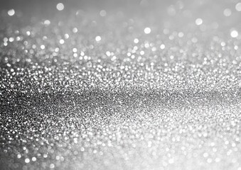 Naklejka premium Close-up of silver glitter texture with sparkling bright bokeh lights creating a shimmering pattern