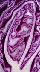 Obraz premium Close-up of sliced purple cabbage revealing intricate natural patterns and fresh vegetable texture. 