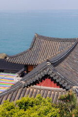 Fototapeta premium Busan, South Korea, Haedong Yonggungsa Temple view, Buddhist temple in Gijang-gun, coastal sea landscape with shrine facade exterior, Gijang County, Northern Busan, Yeongnam region, sunny spring day