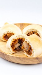Fluffy steamed buns with savory meat filling on wood plate