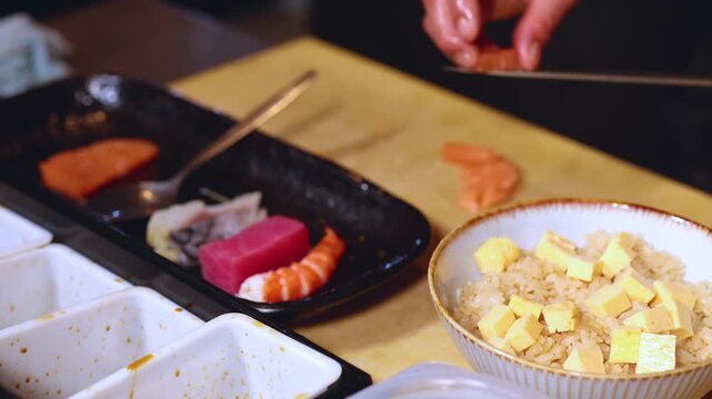 Professional Chef Preparing Japanese Chirashi Sushi Bowl with Fresh Raw Fish