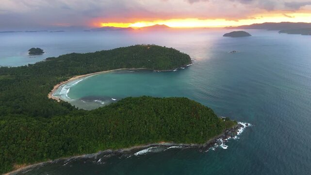 Aerial drone view of a lush tropical coastline and hidden beach in San Vicente, Palawan, Philippines during a dramatic sunset. Stunning Southeast Asia travel destination