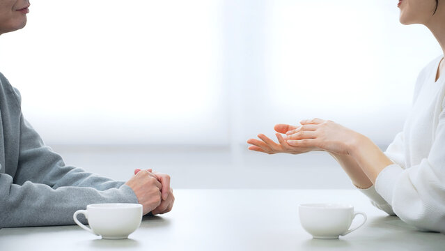 A male and female couple talking in a room