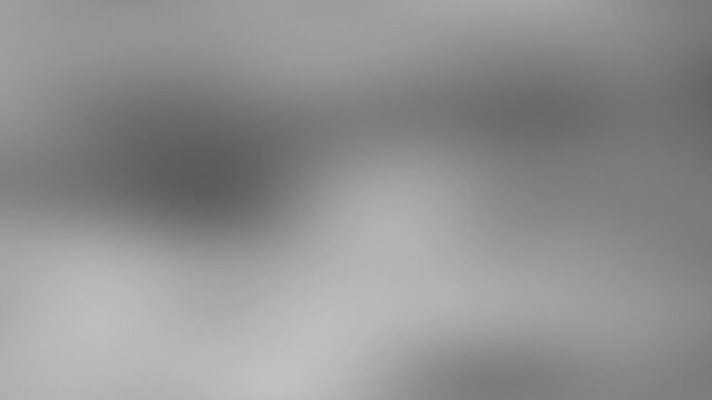 Abstract gray background with blurred shapes and soft textures for design.