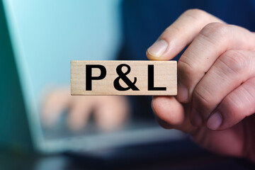 P&L Profit and Loss Statement Concept on Wooden Block for Business Finance