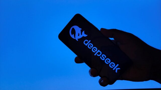 Hand holding smartphone with deepseek logo on screen
