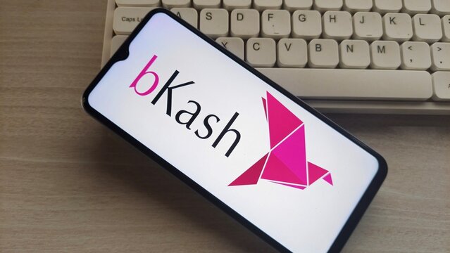 Mobile phone displaying bKash logo on screen with keyboard