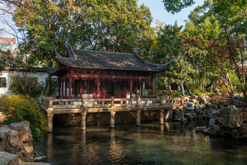 Fototapeta premium The Nine Lion Study Pavilion on the shore of the pond in the Yuyuan Garden (Yu Garden) on a sunny day, Shanghai, China