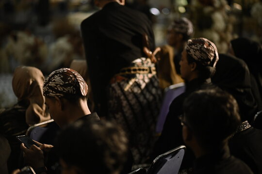 Men in Traditional Javanese Batik Attire and Blangkon During Wedding Ceremony