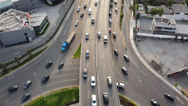 aerial highway view over lima showing multilane traffic, overpass and roundabout at golden hour
