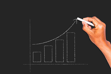 Chalk handwritten bar graph symbols on a blackboard.