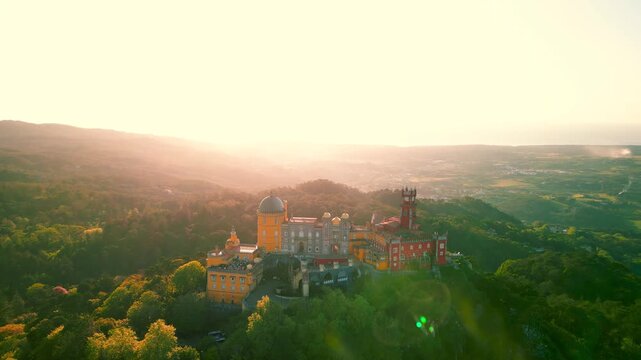 Aerial view of the pena palace, a romanticist castle in Sintra, portugal, during a glowing sunset.