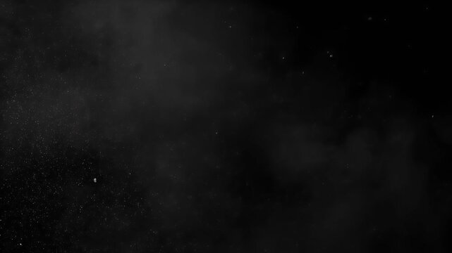 Dark, grainy, abstract background with scattered specks