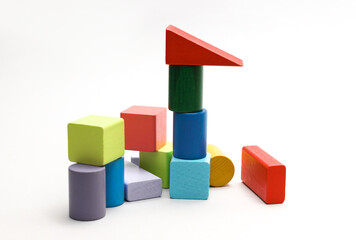 Obraz premium Children's toy colored cubes, a wooden construction set of different geometric shapes for developing logic and motor skills of a little baby