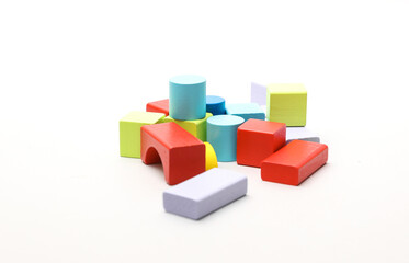 Obraz premium Children's toy colored cubes, a wooden construction set of different geometric shapes for developing logic and motor skills of a little baby