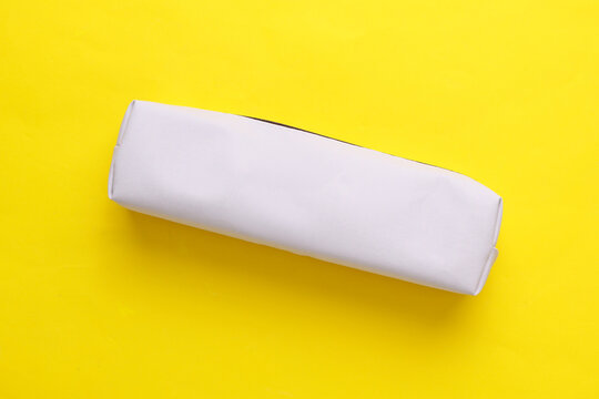 White pencil case mockup on a yellow background
