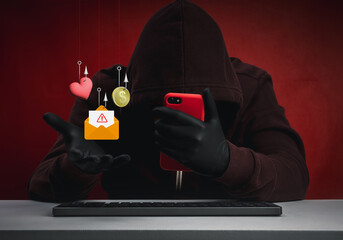 Scammer in hoodie using red mobile phone to commit online fraud, including romance scams, money traps, and phishing messages. Concept of digital deception, emotional manipulation, and cybercrime.