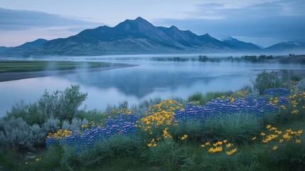 Misty mountain landscape with wildflowers by a tranquil river.