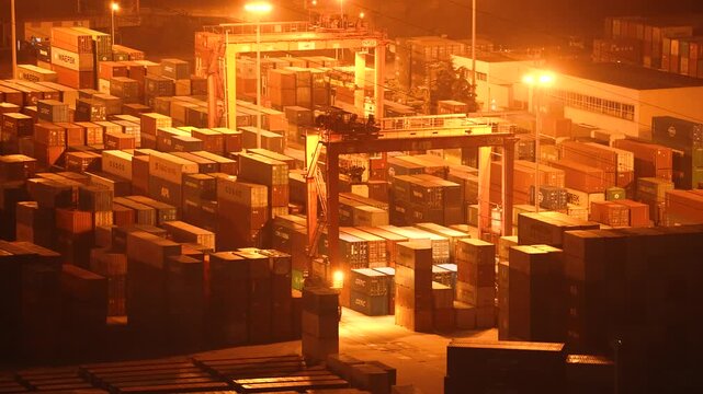 A dynamic aerial time-lapse capturing the rhythmic pulse of global trade at a bustling port, with massive container ships and synchronized cranes under dramatic skies.