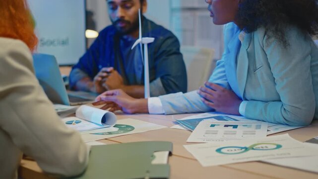 group of multiethnic businesspeople in team meeting,using tablet computer for Net zero,ESG topic presentation on monitor. Sustainable business practice,global warming,earth day,ESG team concept