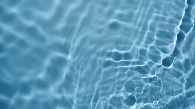 Blue-toned abstract water surface with light reflections