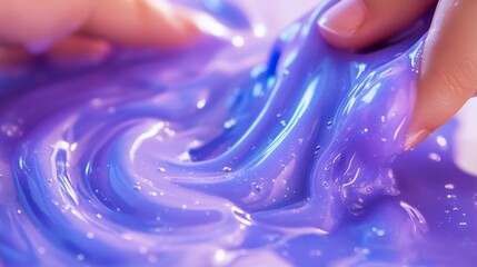 23061731 85 Macro photography of fingers squeezing and folding glossy periwinkle slime creating interesting folding patterns and air pockets, DIY Very Peri colored homemade slime with visible