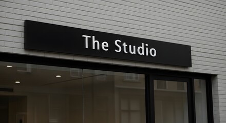Fototapeta premium Modern studio sign on brick building facade