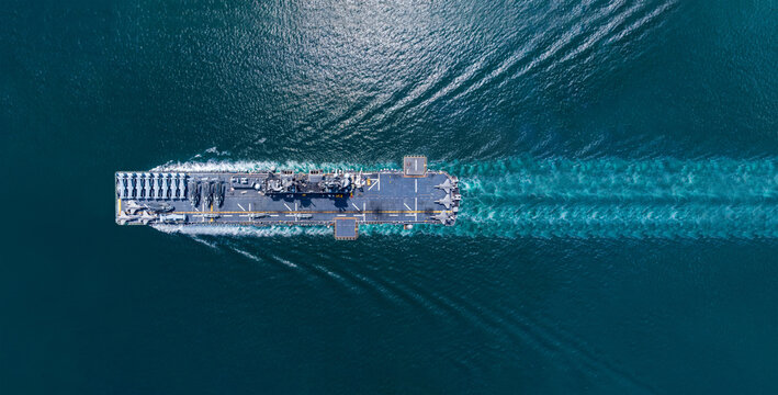 Nuclear ship warship Military navy ship carrier full loading fighter jet aircraft and Helicopters sailing in the ocean. Military warship deck loaded with fighter jets Naval defense power army force
