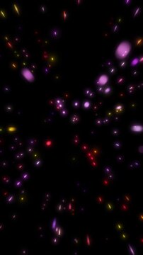 Abstract video footage of colorful particles exploding and scattering.