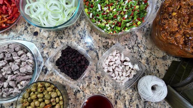 Top down visible ingredients, such as ground meats, bell peppers, onions, olives, and raisins, are typical of this Christmas dish. Laborious preparation process