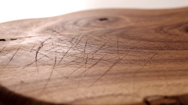 Rustic wood cutting board texture close up with scratches and imperfections