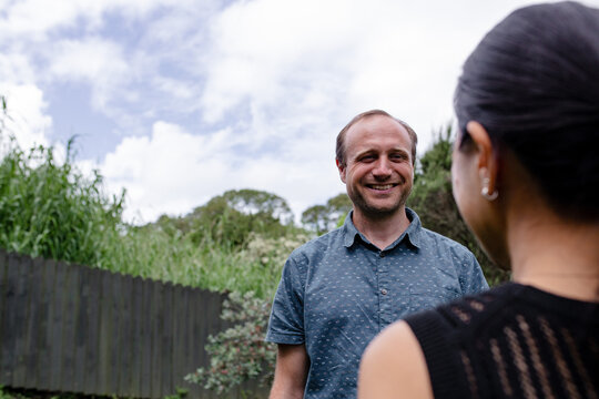 Couple with mixed ethnicity standing in the backyard
