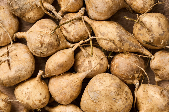 flat lay pile of jicama or yam bean on wood table background      
