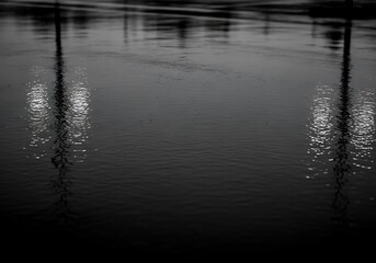Eerie reflections casting over waters in an abstract monochrome scenery