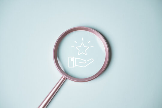Minimal concept image of loyalty rewards and redeem points shown through magnifying glass icon with star and hand. Ideal for business, finance, customer retention, digital marketing, and reward.