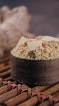 closeup of ginger powder in a wooden spoon 